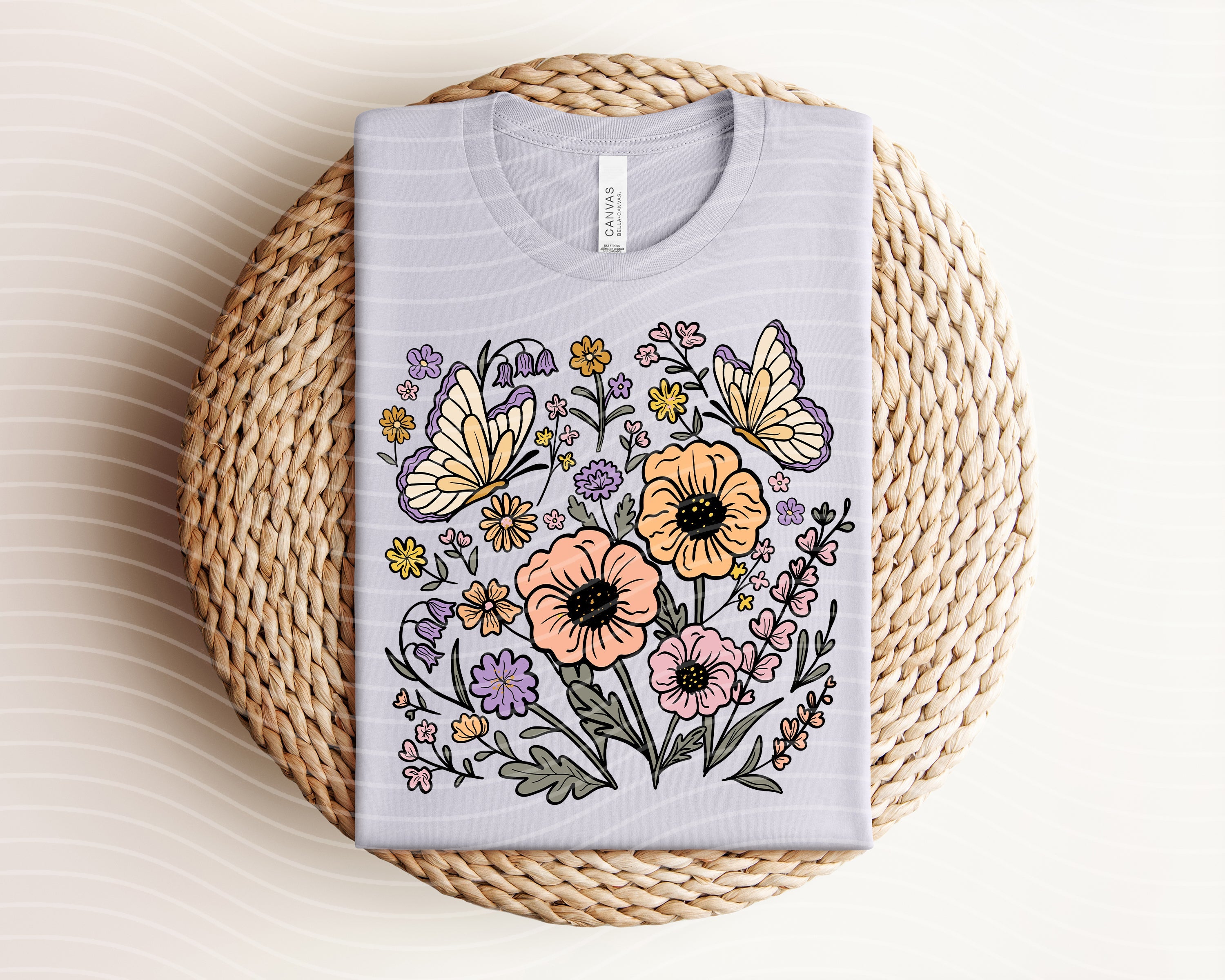 Spring floral graphic tee by Anchored Grace Boutique featuring colorful floral design on a comfortable cotton t-shirt.