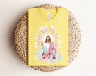 Jesus Shining graphic tee by Anchored Grace Boutique, featuring a vibrant religious design on a casual cotton t-shirt.