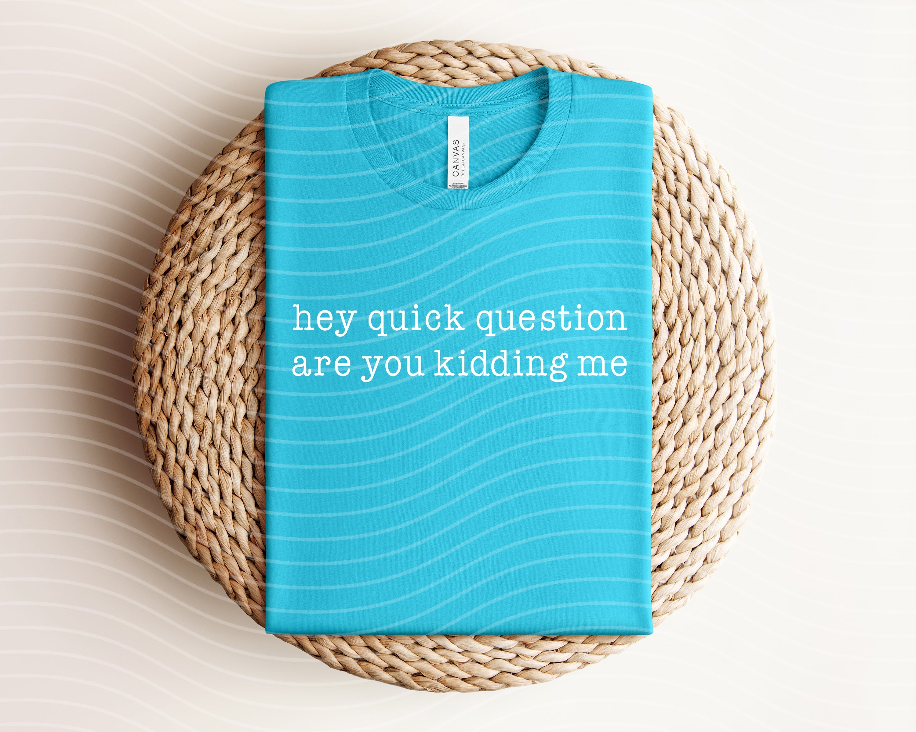 Gray graphic tee from Anchored Grace Boutique with "Hey Quick Question" text on the front, casual style perfect for everyday wear.