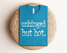 Black unhinged but hot graphic tee from Anchored Grace Boutique featuring bold white text and casual fit.