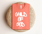 Child of God graphic tee for kids, featuring faith-inspired design from Anchored Grace Boutique, displayed on a white background.