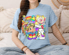 Colorful rainbow graphic tee from Anchored Grace Boutique, featuring vibrant rainbow print on casual cotton t-shirt.