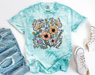 Spring floral graphic tee from Anchored Grace Boutique featuring a colorful floral design on soft fabric.
