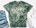 Black Shamrocks graphic tee by Anchored Grace Boutique featuring a vibrant shamrock design on soft cotton fabric.