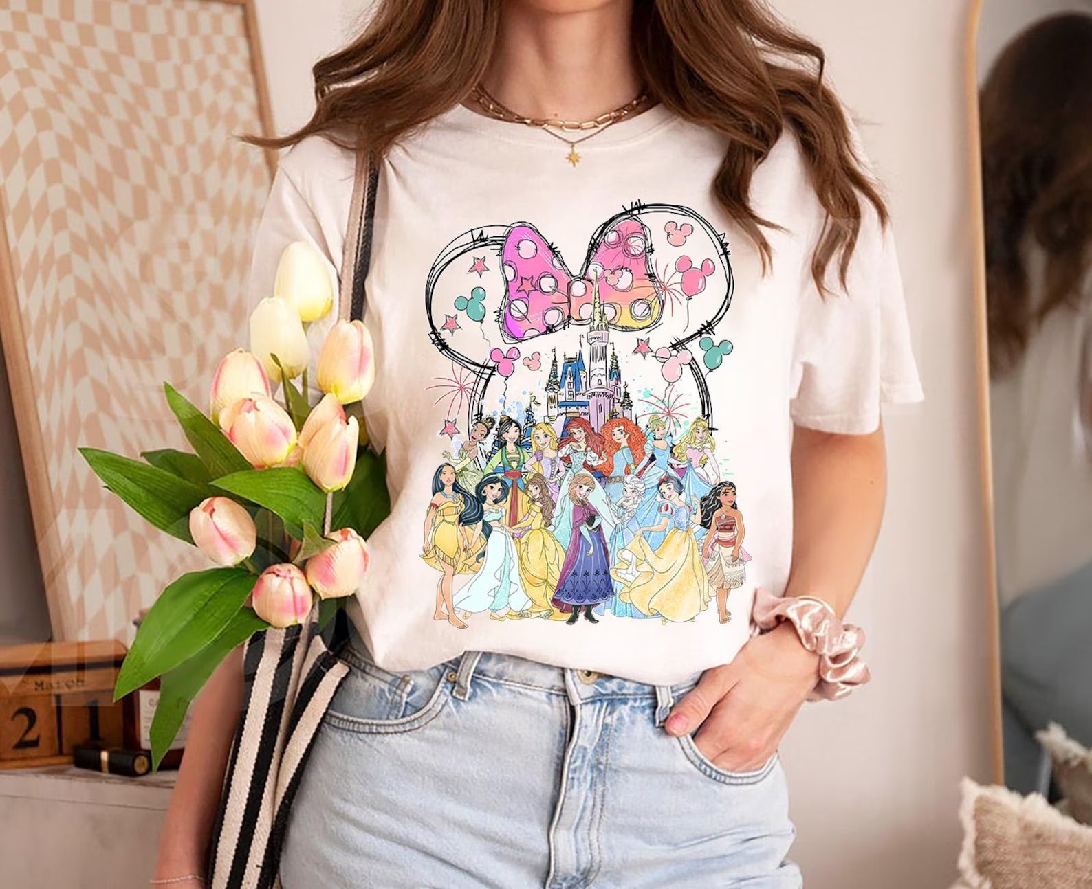Pink magical princesses graphic tee for girls by Anchored Grace Boutique, featuring colorful princess illustrations on soft fabric.