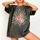 Cross stitch roses graphic tee from Anchored Grace Boutique featuring detailed floral embroidery on a casual t-shirt.