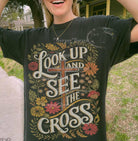 Black graphic tee featuring a cross design from Anchored Grace Boutique's Look Up and See collection.