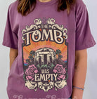 Black graphic tee featuring "The Tomb Was Empty" text from Anchored Grace Boutique, casual unisex t-shirt with bold design.