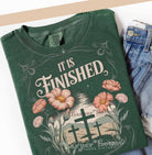 Black graphic tee with "It Is Finished" print from Anchored Grace Boutique, featuring a casual fit and modern design.
