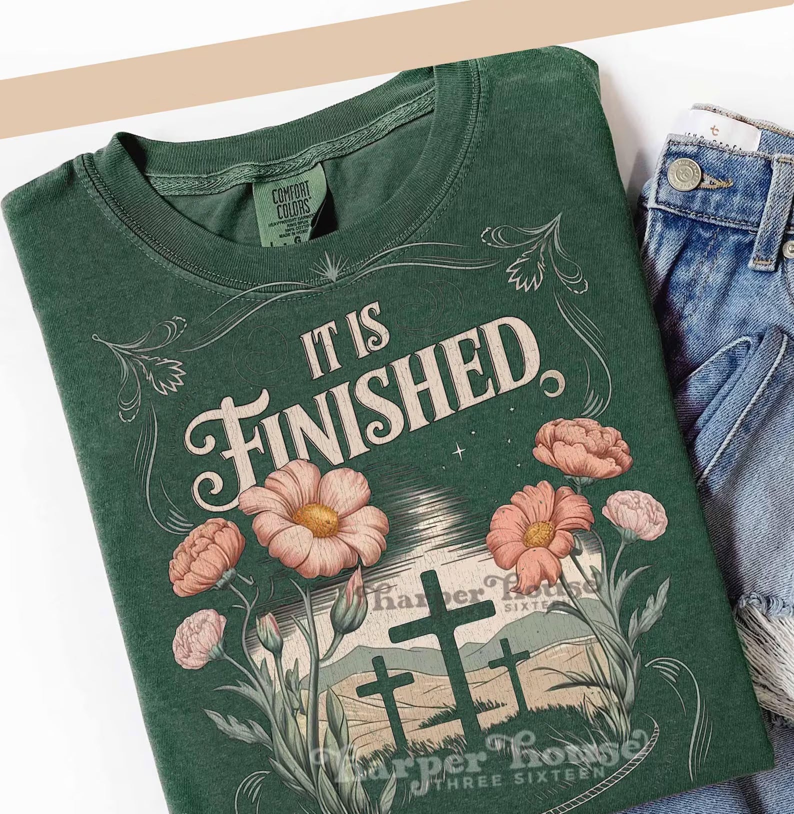 Black graphic tee with "It Is Finished" print from Anchored Grace Boutique, featuring a casual fit and modern design.
