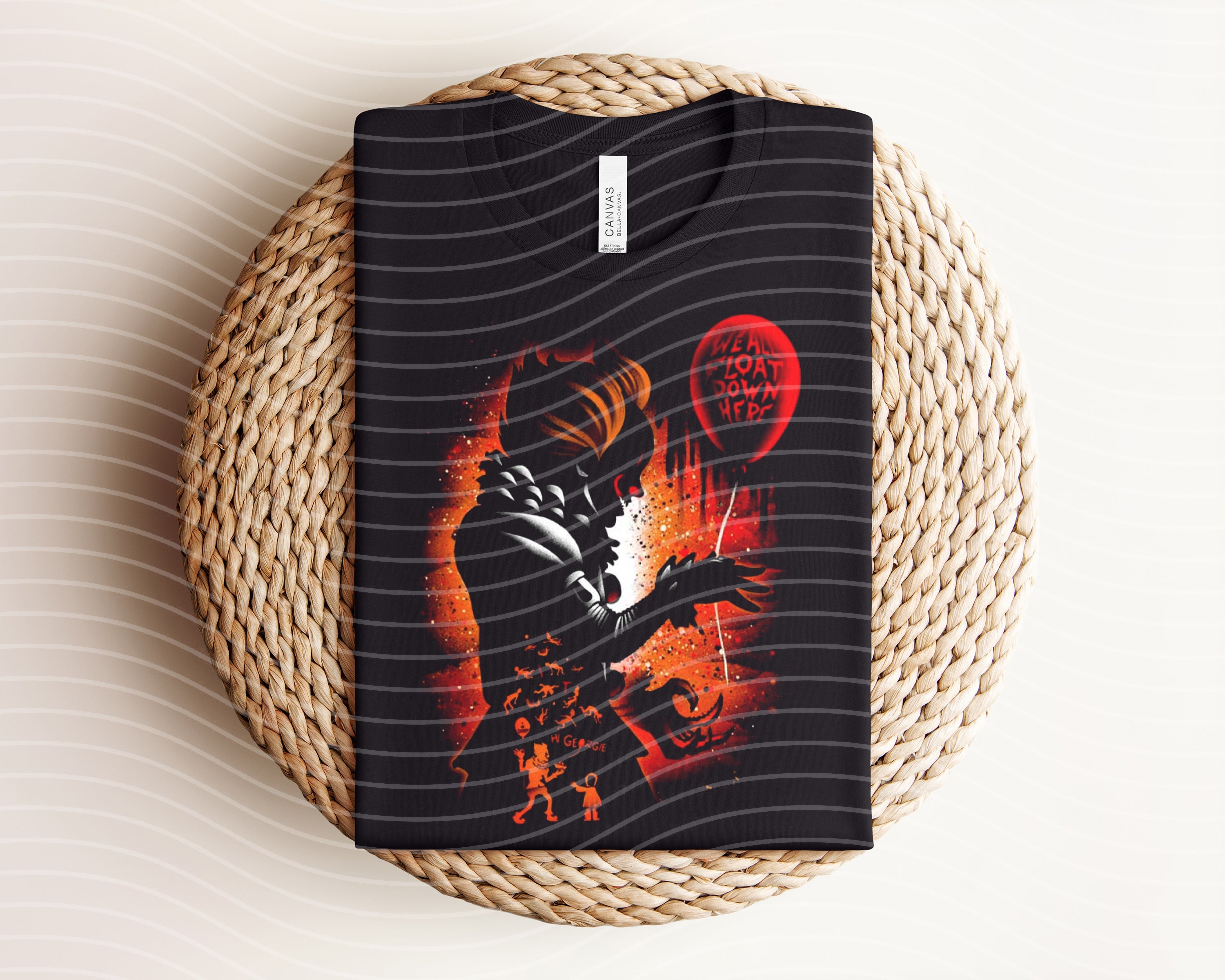Dark graphic tee featuring Pennywise from Stephen King’s It, with horror-themed design, by Anchored Grace Boutique.