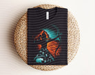 Anchored Grace Boutique Merida Dark Graphic Tee featuring bold graphic design on a black t-shirt for casual style.