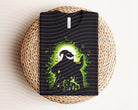 Oogie Boogie dark graphic tee from Anchored Grace Boutique featuring a spooky cartoon design on black fabric.