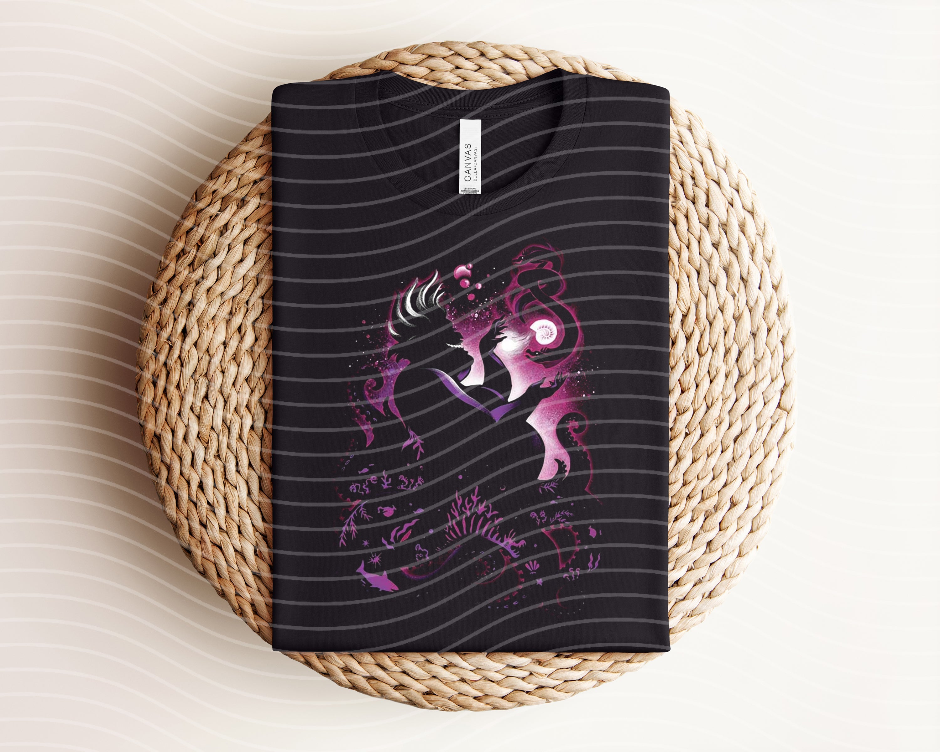 Dark graphic tee featuring Ursula design from Anchored Grace Boutique, casual fashion top with bold artistic print.