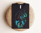 Moana dark graphic tee featuring a vibrant graphic design, casual fit, from Anchored Grace Boutique.