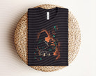 Pocahontas dark graphic tee from Anchored Grace Boutique featuring a detailed graphic design on soft black fabric.