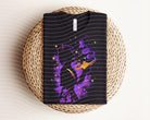 Aladdin dark graphic tee by Anchored Grace Boutique featuring a vibrant, artistic design on a black cotton T-shirt.