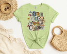 Black One More Chapter graphic tee by Anchored Grace Boutique featuring a stylish book-themed design on soft cotton fabric.