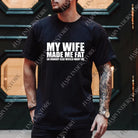 Black graphic tee from Anchored Grace Boutique with humorous "My Wife Made Me Fat" design, casual fit, and soft fabric.