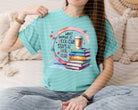 Black graphic tee from Anchored Grace Boutique featuring the phrase "What Happens at Book Club Stays at Book Club" in bold white letters.