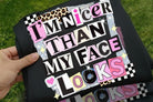 Black graphic tee from Anchored Grace Boutique with bold white text saying "I'm Nicer Than My Face Looks" on the front.
