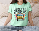 Captain of the Struggle Bus graphic tee by Anchored Grace Boutique, featuring a humorous bus illustration on a casual t-shirt.