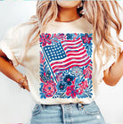 Flag and flowers graphic tee by Anchored Grace Boutique featuring a vibrant patriotic design on a casual t-shirt.