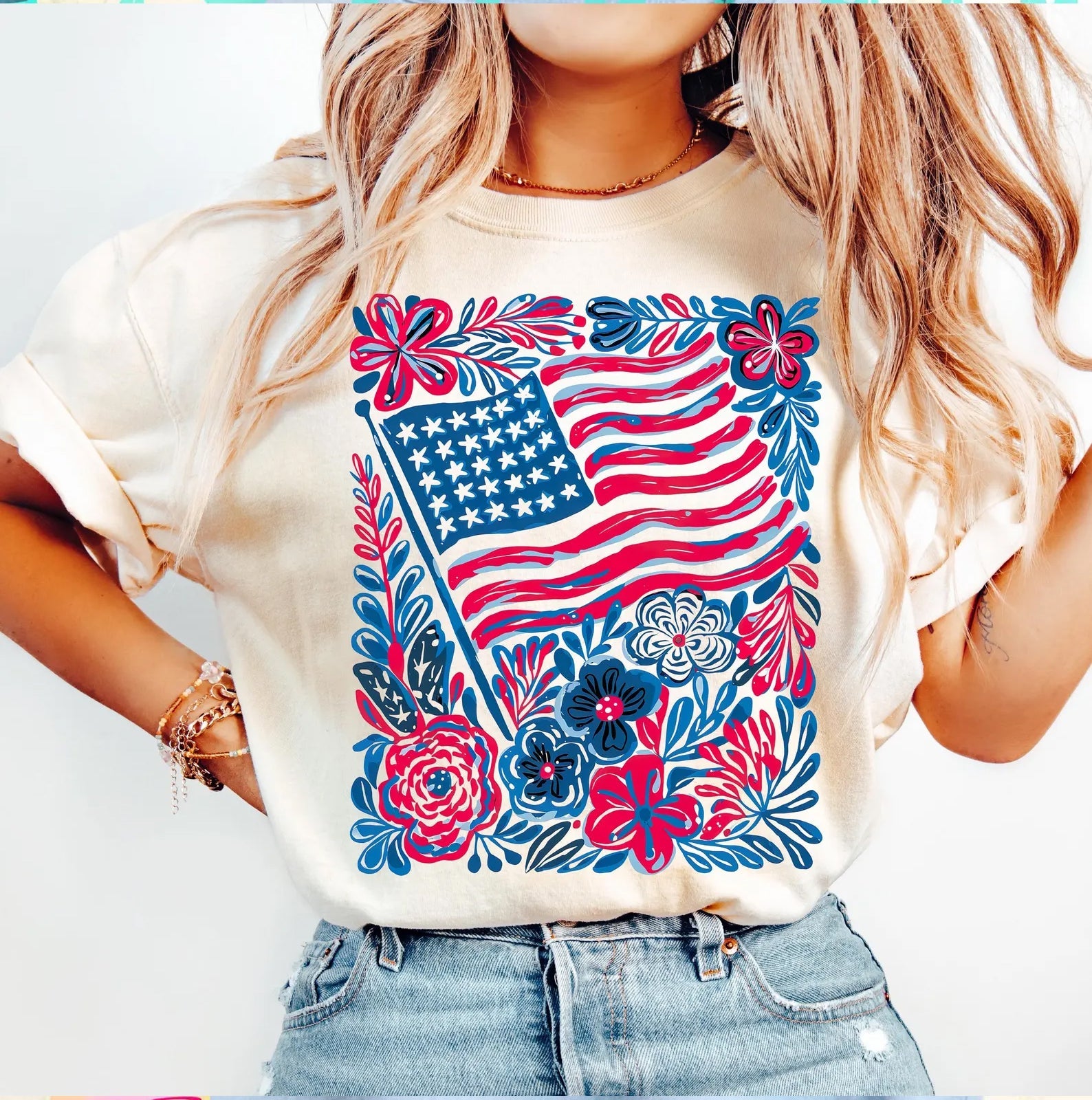 Flag and flowers graphic tee by Anchored Grace Boutique featuring a vibrant patriotic design on a casual t-shirt.