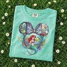 Ariel Friend graphic tee from Anchored Grace Boutique featuring a colorful, playful design on a casual cotton t-shirt.