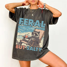 Feral But Salty graphic tee from Anchored Grace Boutique featuring a bold, colorful design on a casual cotton t-shirt.