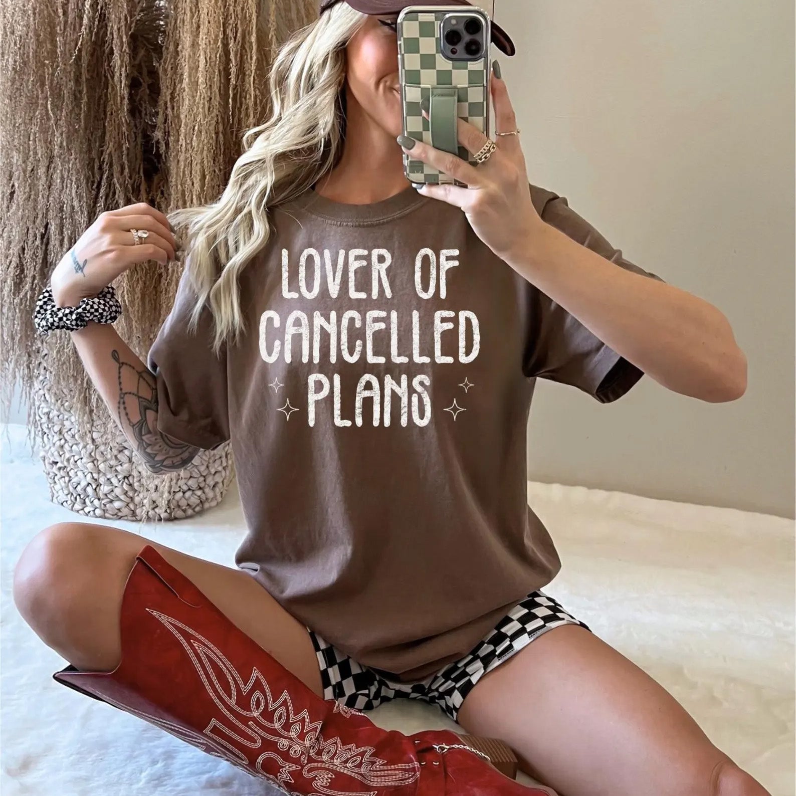 Black graphic tee from Anchored Grace Boutique featuring the phrase "Lover of Cancelled Plans" in stylish white lettering.