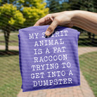 Black graphic tee featuring a fat raccoon illustration and the phrase "My Spirit Animal is a Fat Raccoon" by Anchored Grace Boutique.