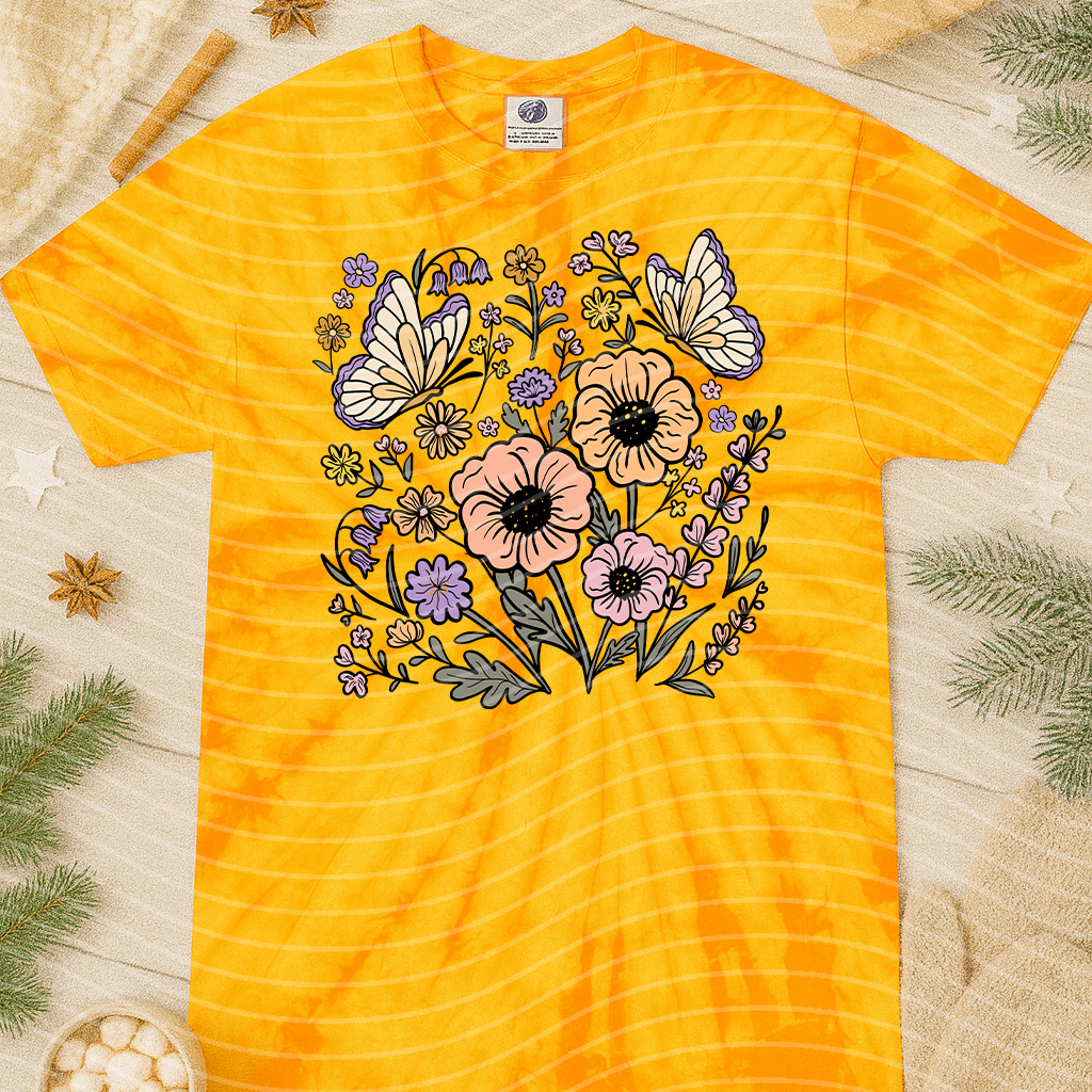 Spring floral graphic tee from Anchored Grace Boutique featuring colorful flower designs and casual fit.