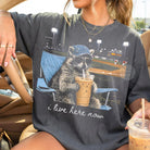 Black I Live Here Now graphic tee by Anchored Grace Boutique featuring bold white text on soft cotton fabric.