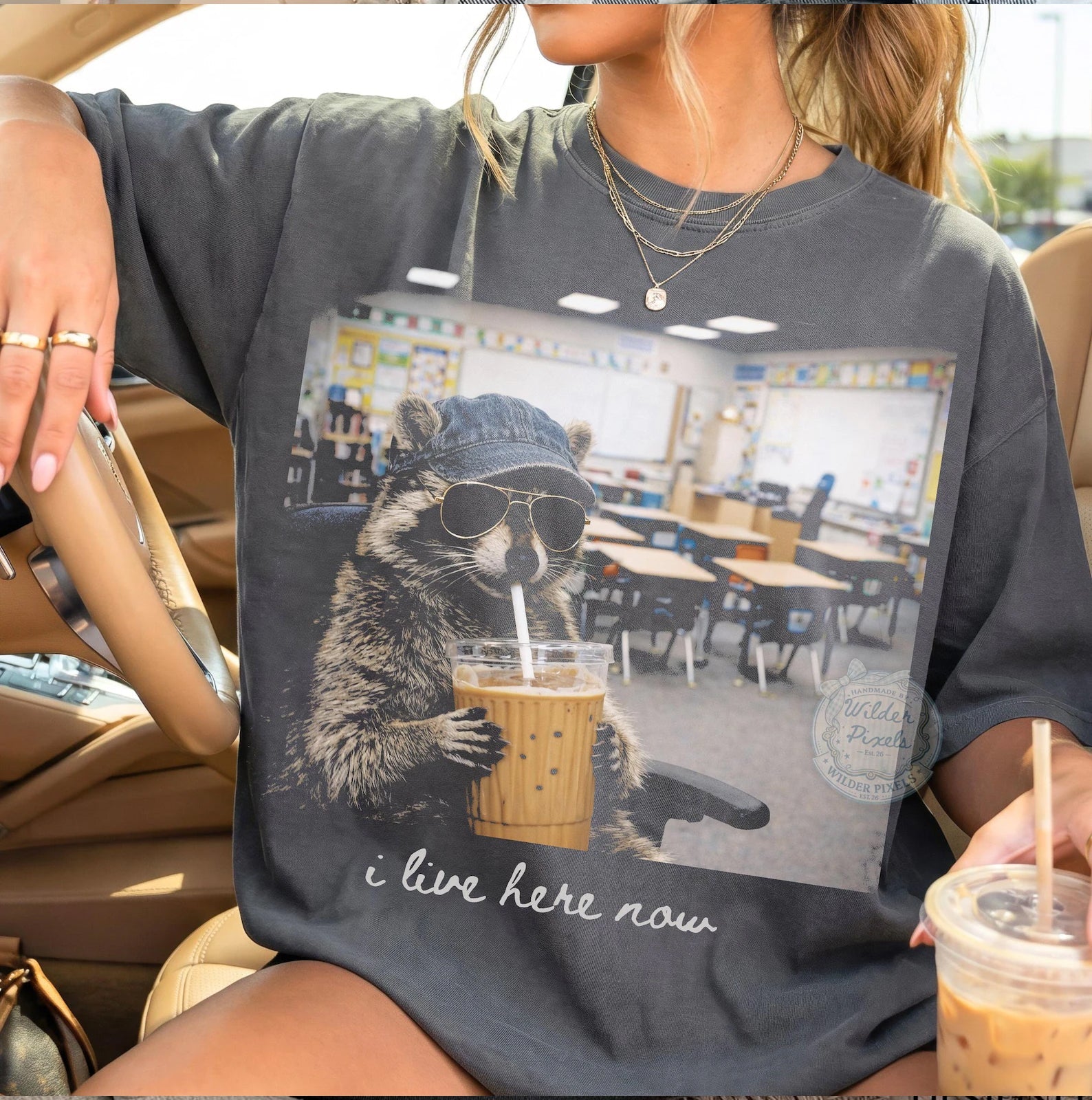 Black graphic tee from Anchored Grace Boutique with "I Live Here Now" print, casual style, and comfortable fit.