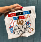Anchored Grace Boutique Take Me Out to the Ball Game graphic tee, casual shirt with baseball-themed design and fun lettering.