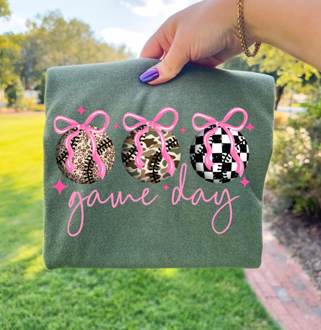 Anchored Grace Boutique Game Day Bows graphic tee featuring a colorful bow design on a casual cotton t-shirt.