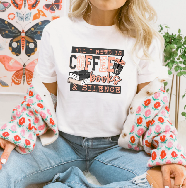 All I Need is Coffee Books & Silence graphic tee by Anchored Grace Boutique, featuring a casual design with coffee and book illustrations.
