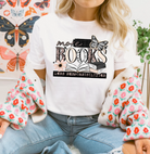 Gray graphic tee from Anchored Grace Boutique featuring the phrase "More Books Less Responsibilities" in bold lettering.