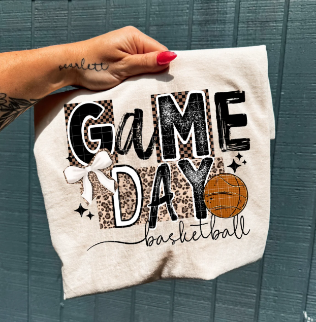 Basketball graphic tee from Anchored Grace Boutique featuring sporty game day design on a casual cotton shirt.