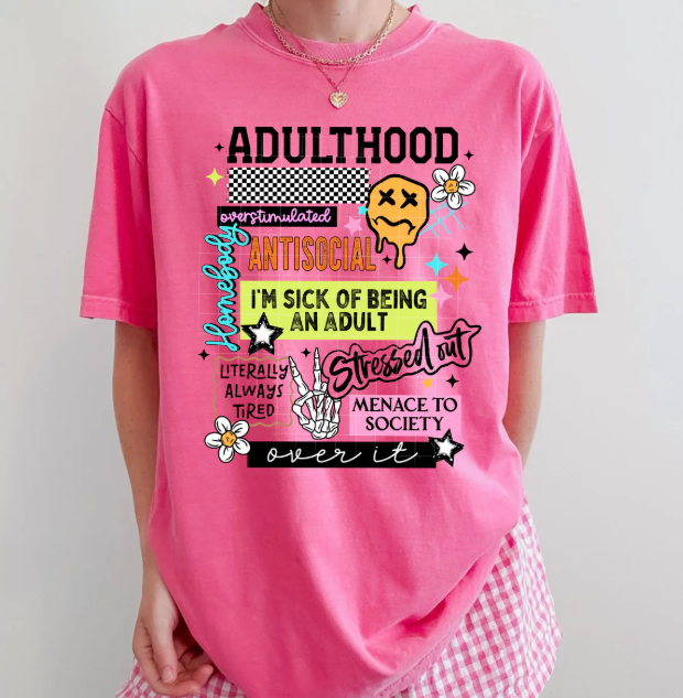 Black adulthood graphic tee by Anchored Grace Boutique featuring a modern design and motivational message on the front.