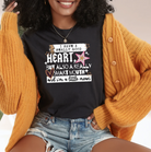 Black graphic tee by Anchored Grace Boutique with "I Have a Really Good Heart" design in white text. Comfortable casual shirt.