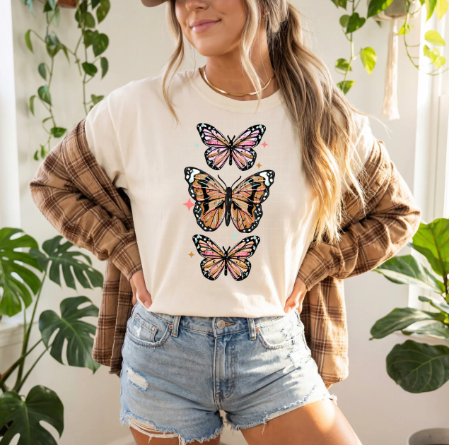 Colorful butterflies graphic tee from Anchored Grace Boutique featuring a vibrant butterfly design on a casual t-shirt.
