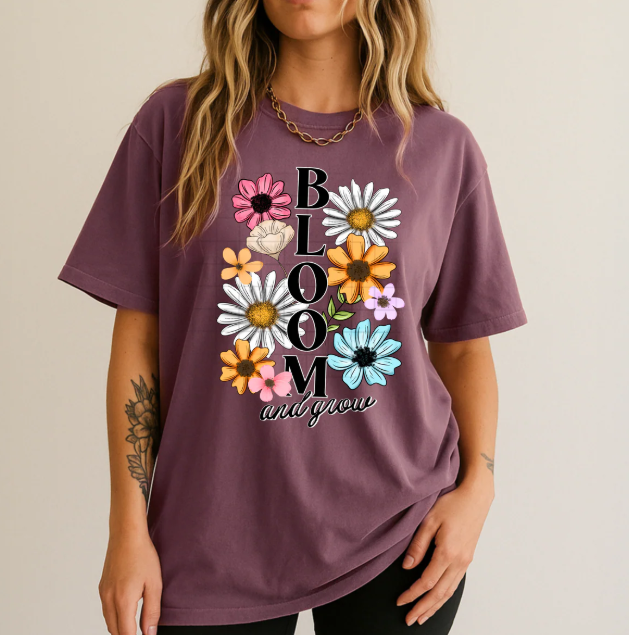 Bloom and Grow graphic tee by Anchored Grace Boutique, featuring a colorful floral design on a casual cotton t-shirt.