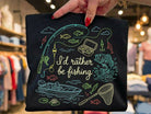Anchored Grace Boutique graphic tee with "I'd Rather Be Fishing" print, casual short-sleeve design for fishing enthusiasts.