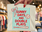 Sunny Days and Double Plays graphic tee by Anchored Grace Boutique, featuring a colorful design on a casual t-shirt.