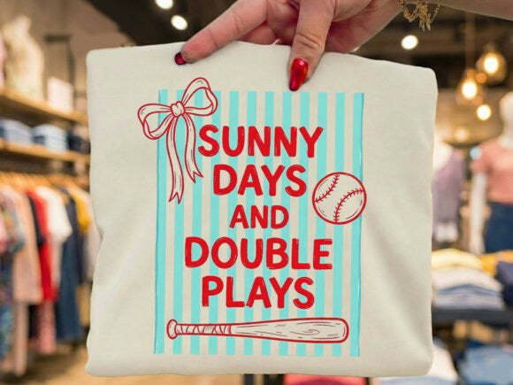 Sunny Days and Double Plays graphic tee by Anchored Grace Boutique, featuring a colorful design on a casual t-shirt.
