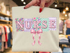 Nurse Coquette graphic tee by Anchored Grace Boutique, featuring stylish nurse-themed design on a casual cotton t-shirt.