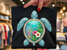 Rhinestone turtle graphic tee from Anchored Grace Boutique featuring a sparkly turtle design on a casual cotton t-shirt.