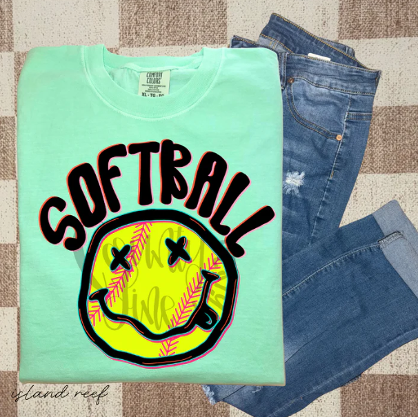 Softball-themed graphic tee by Anchored Grace Boutique featuring a cheerful happy face design, perfect for casual wear.